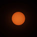 A photo of the sun, taken with ES-FLAR80640CF-iEXOS-100, showing the orange-colored sun with sunspots scattered across the visible surface of the sun